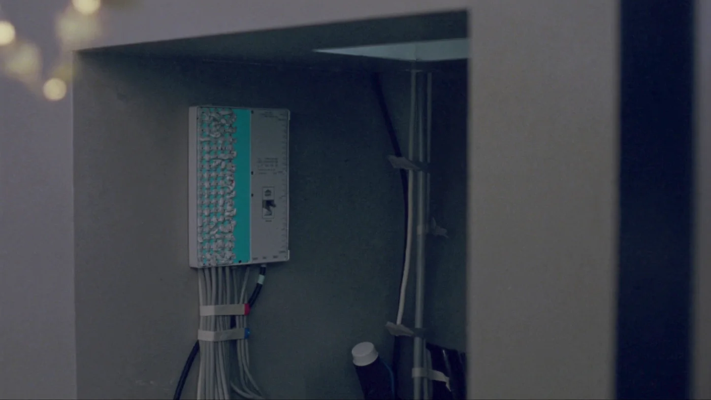A riser cupboard with a data concentrator and neatly dressed cabling