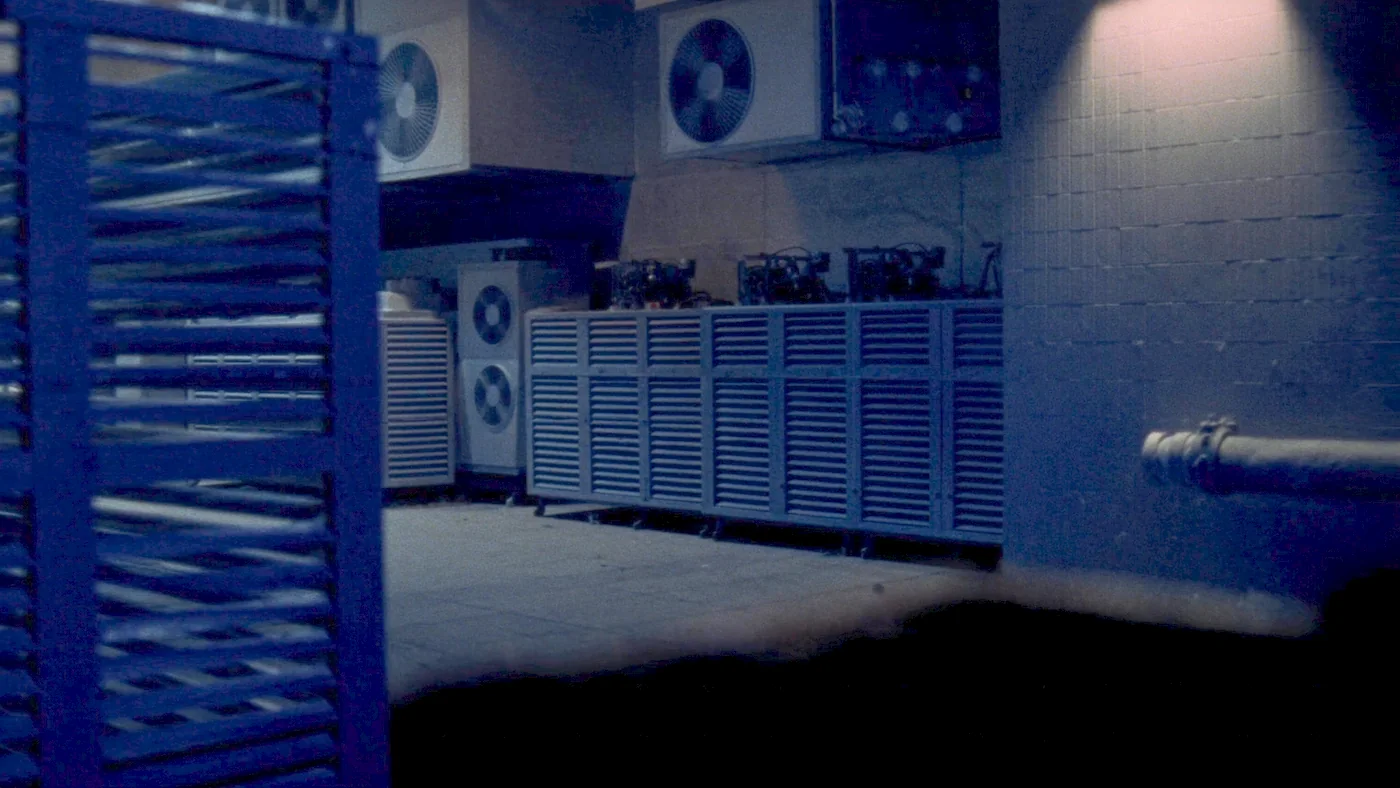 An array of air source heat pumps behind acoustic louvres at a housing scheme