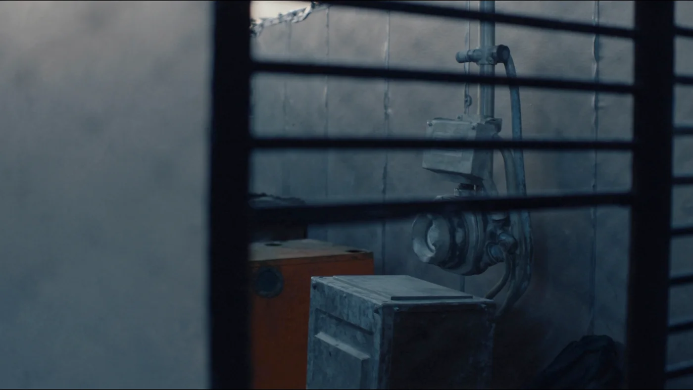 A rooftop gas meter installation behind a louvred enclosure at dusk