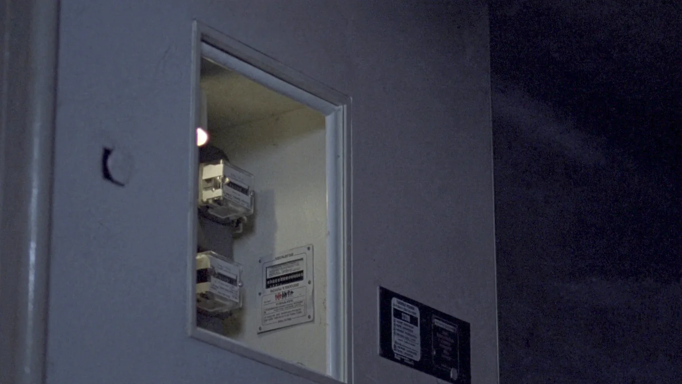 A meter cupboard of electricity meters and isolators in a housing block riser